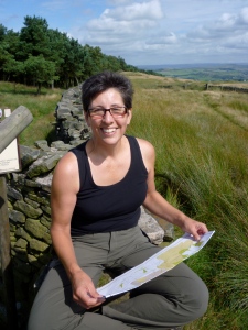 Jacquie reading a map on a hike in the Peak District